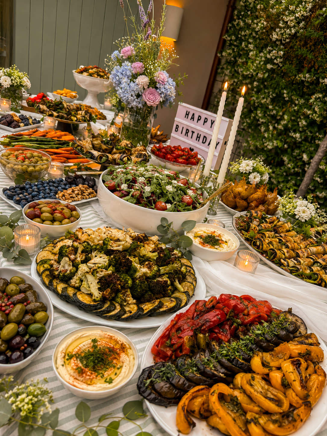 Garden birthday celebration with candles and flowers